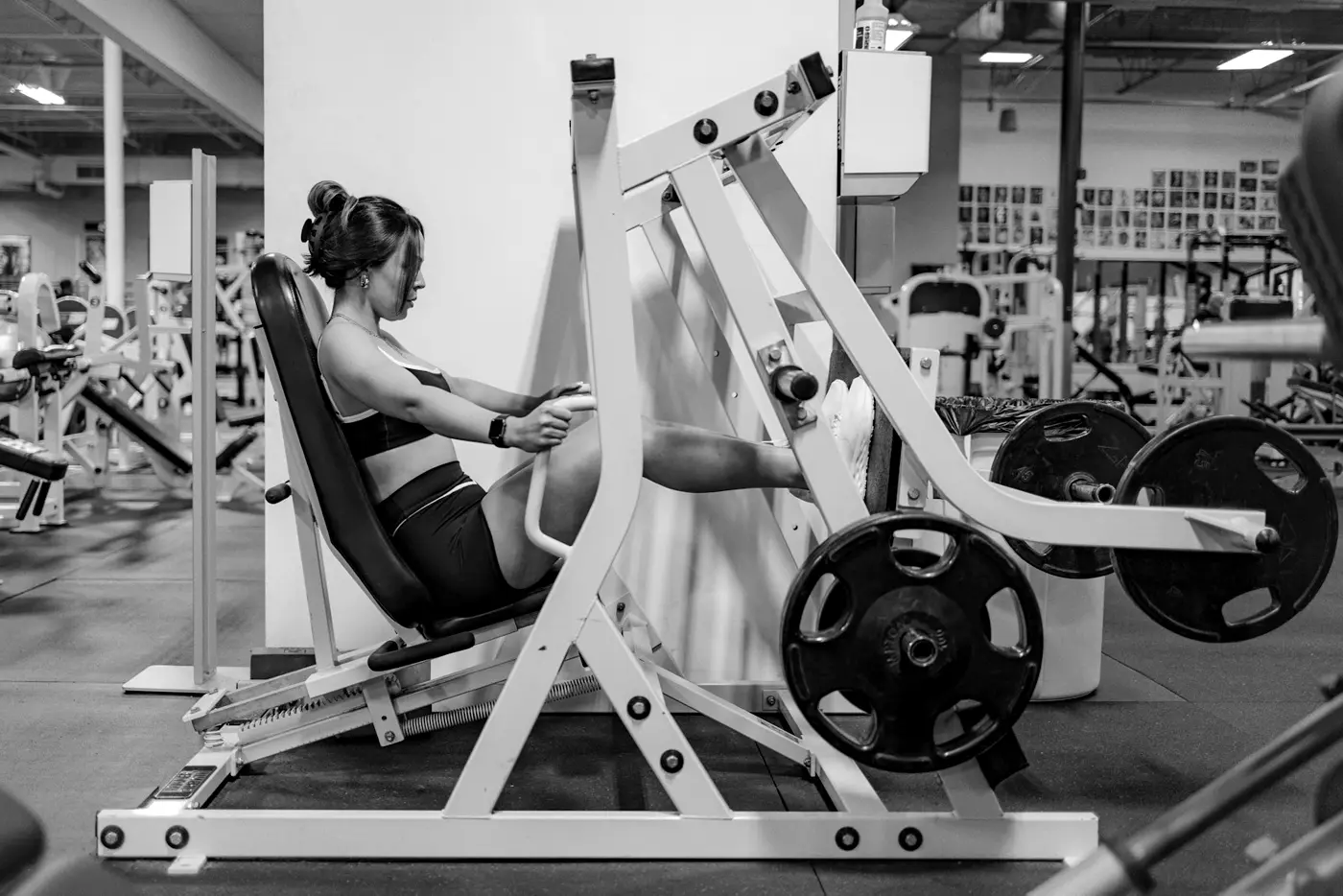 A lifter training on a plate-loaded leg press